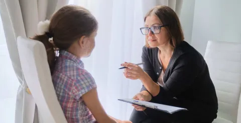 woman social worker talking to a child